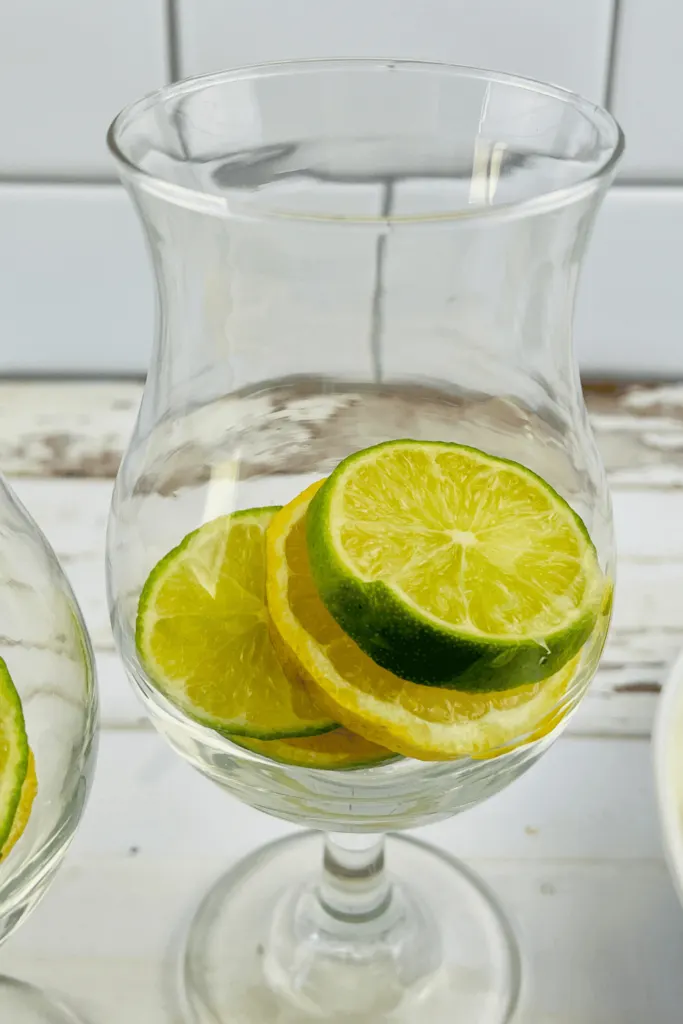 lemon and lime slices in a glass for making lemon water