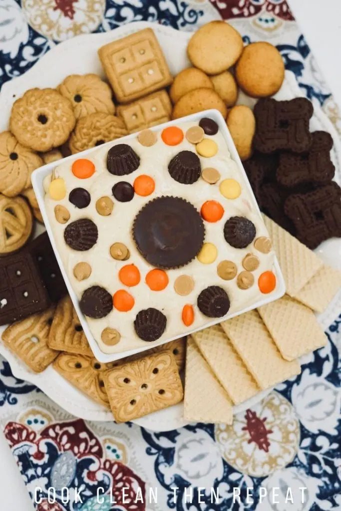 Tall image showing the finished dip on a plate of cookies.