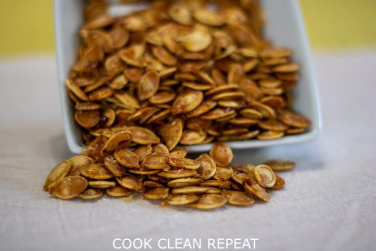 Featured image showing the finished maple roasted pumpkin seeds ready toe at.
