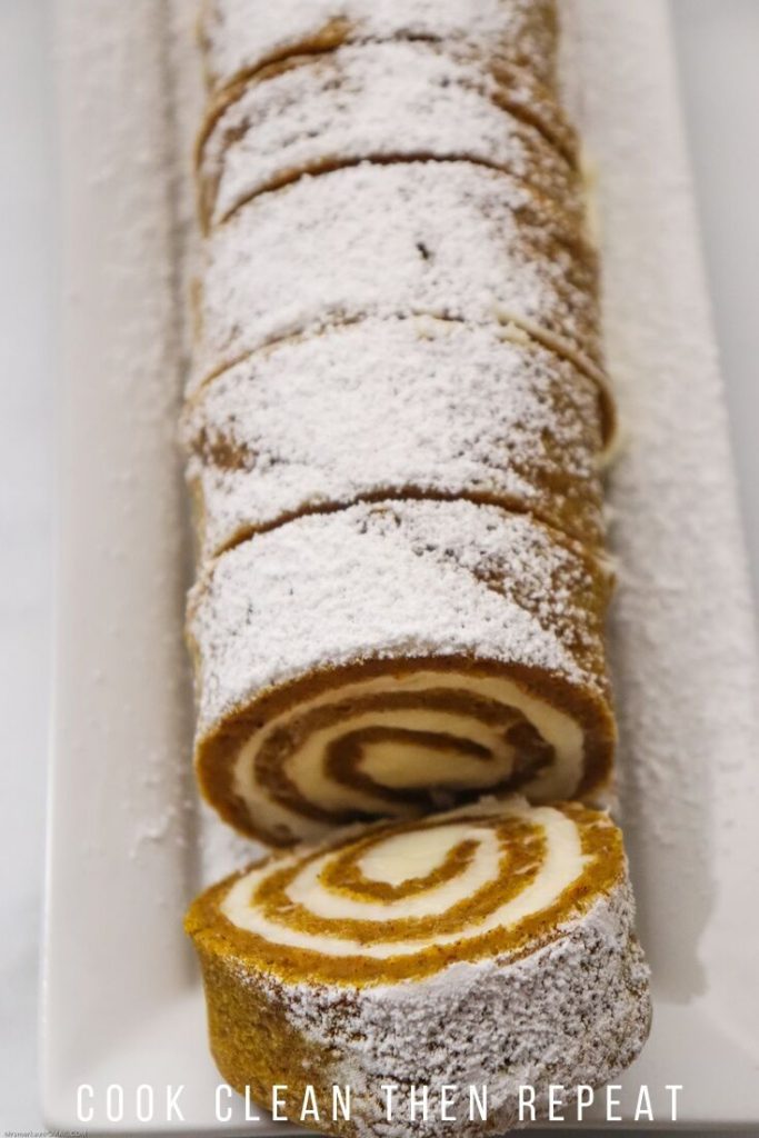 top down view of the whole pumpkin cake roll dessert with slice on the end.