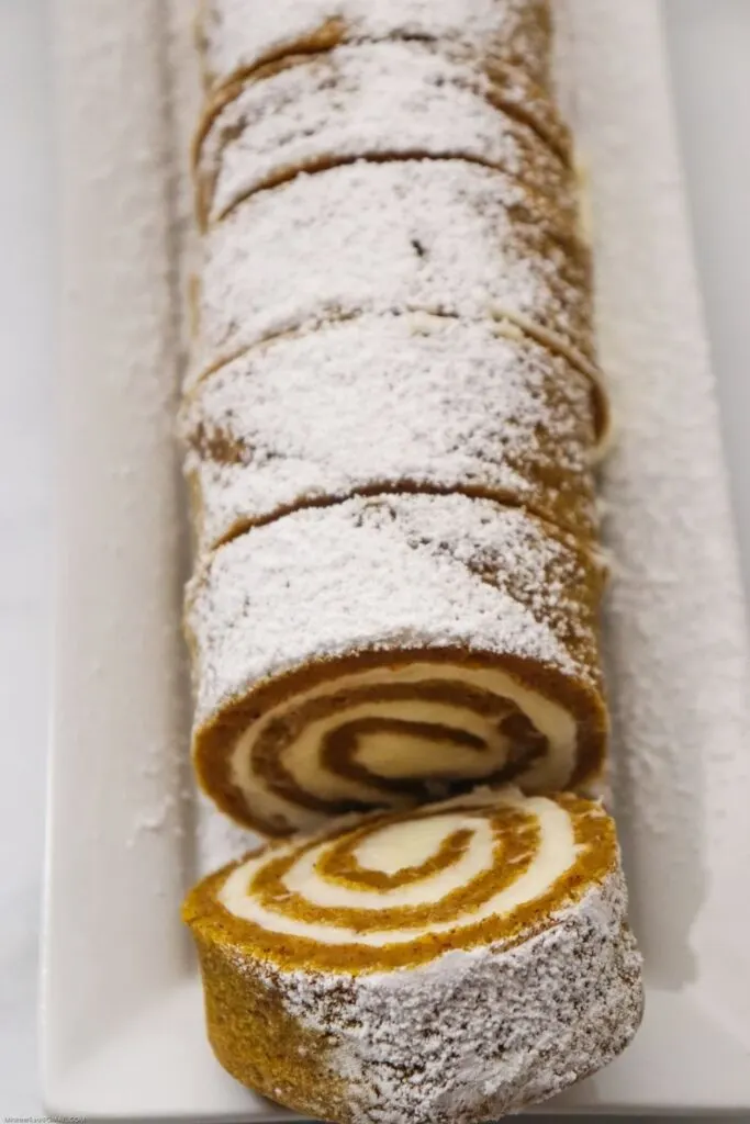 cake roll sliced with powdered sugar on top.