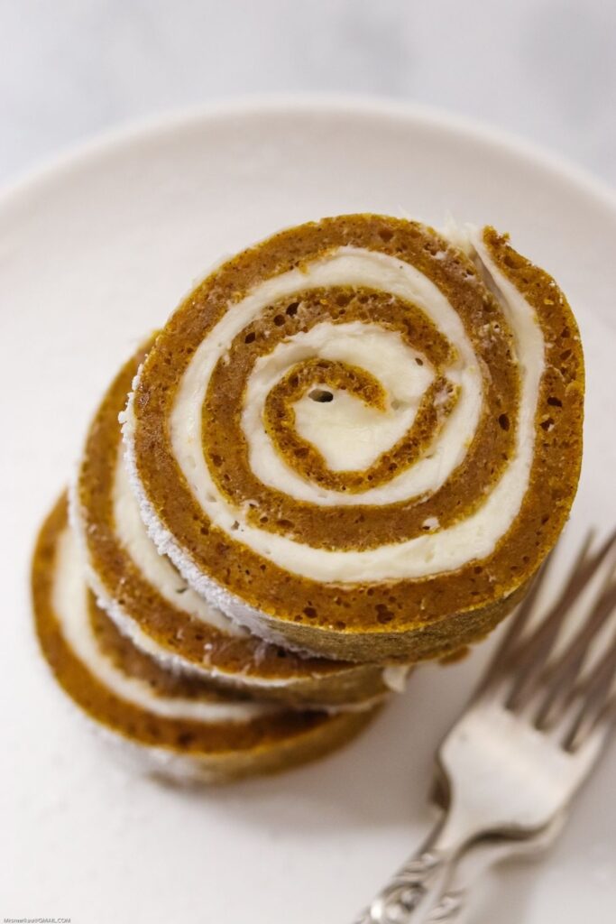 three stacked slices of this easy pumpkin roll recipe