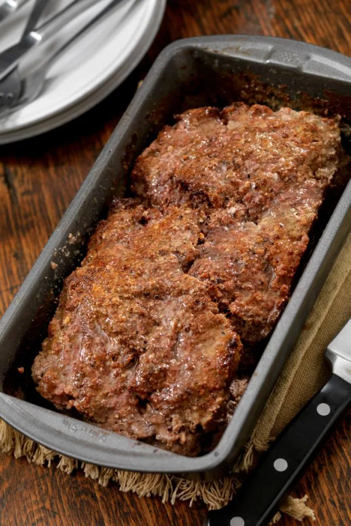 Cooked meatloaf in a loaf pan.
