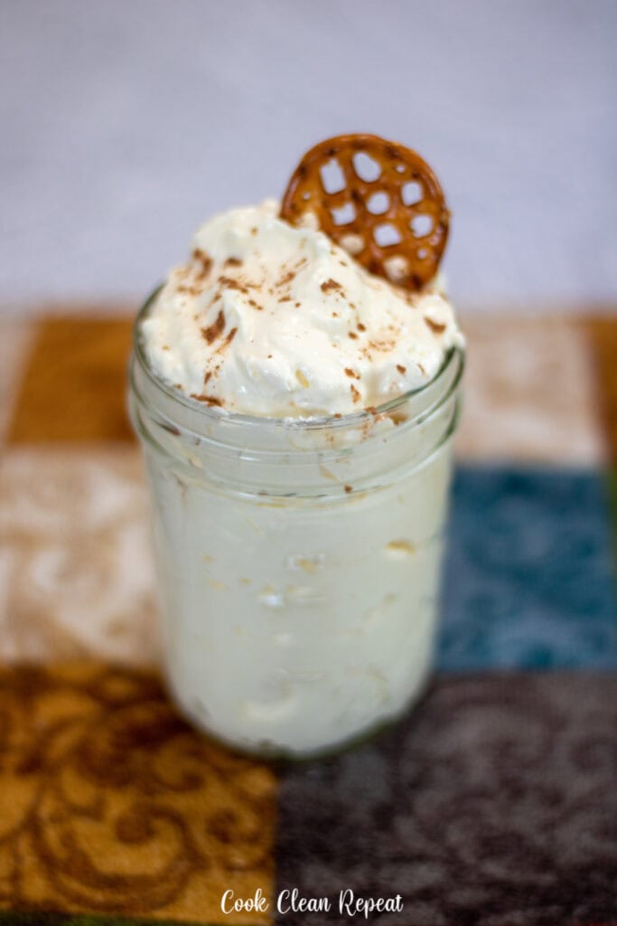 A cup full of the finished cheesecake dip ready to be eaten.