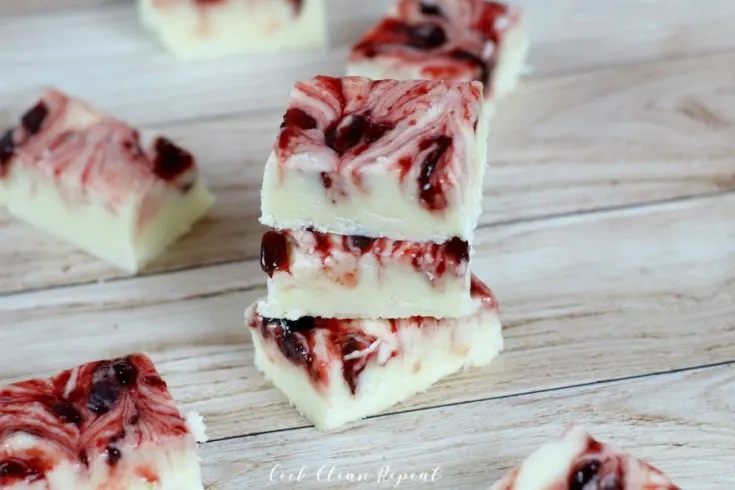 A delicious stack of white chocolate fudge with cherries on top.