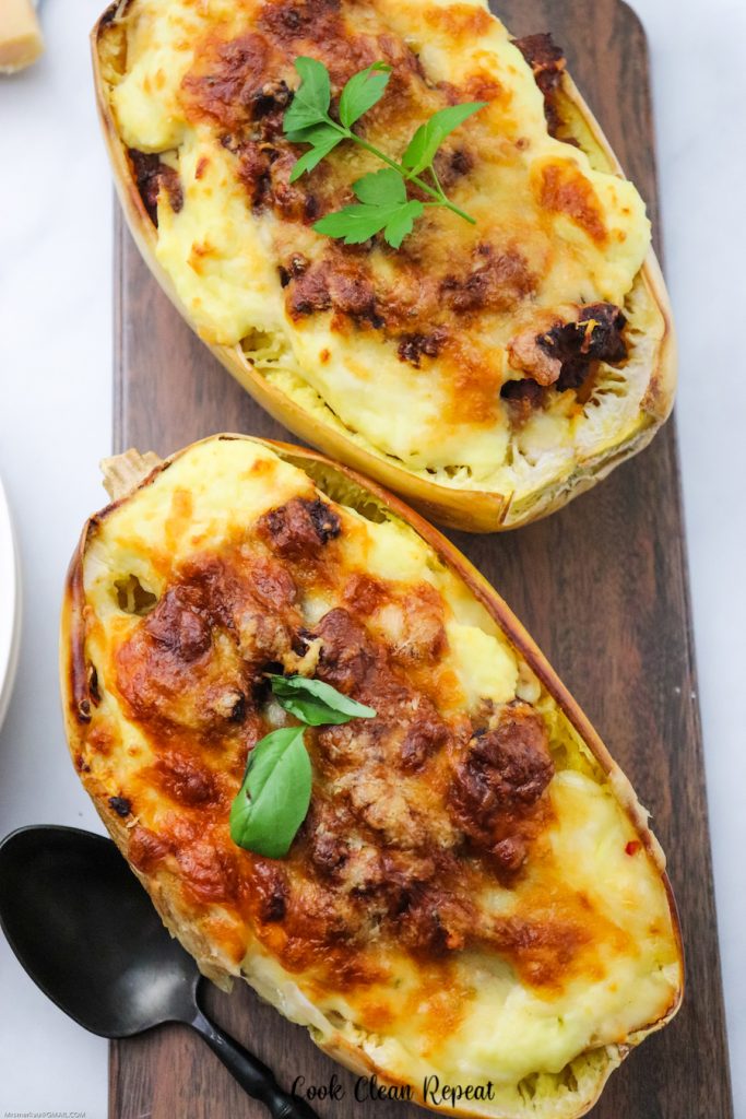 A top down look at two halves of a baked spaghetti squash. 