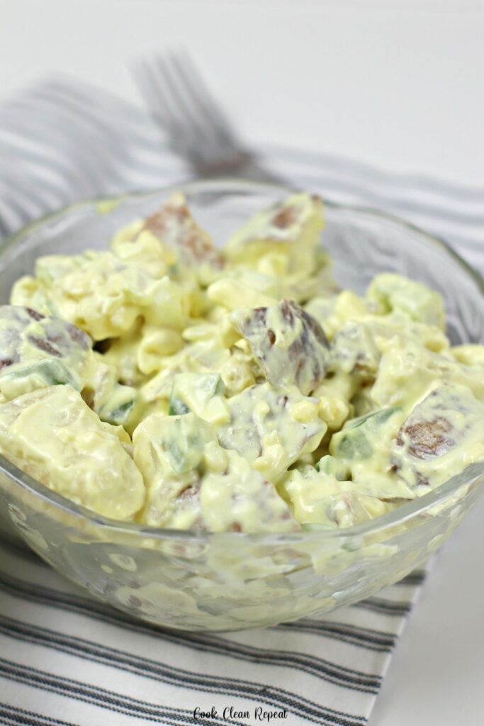A bowl full of the delicious loaded baked potato salad ready to eat. 