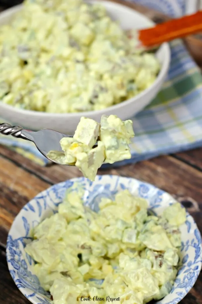 a forkful of the delicious potato salad ready to be served.