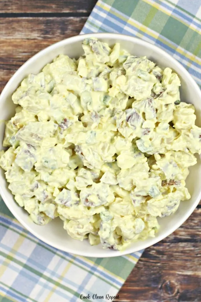 A top down view of the potato salad in a dish ready to be eaten. 