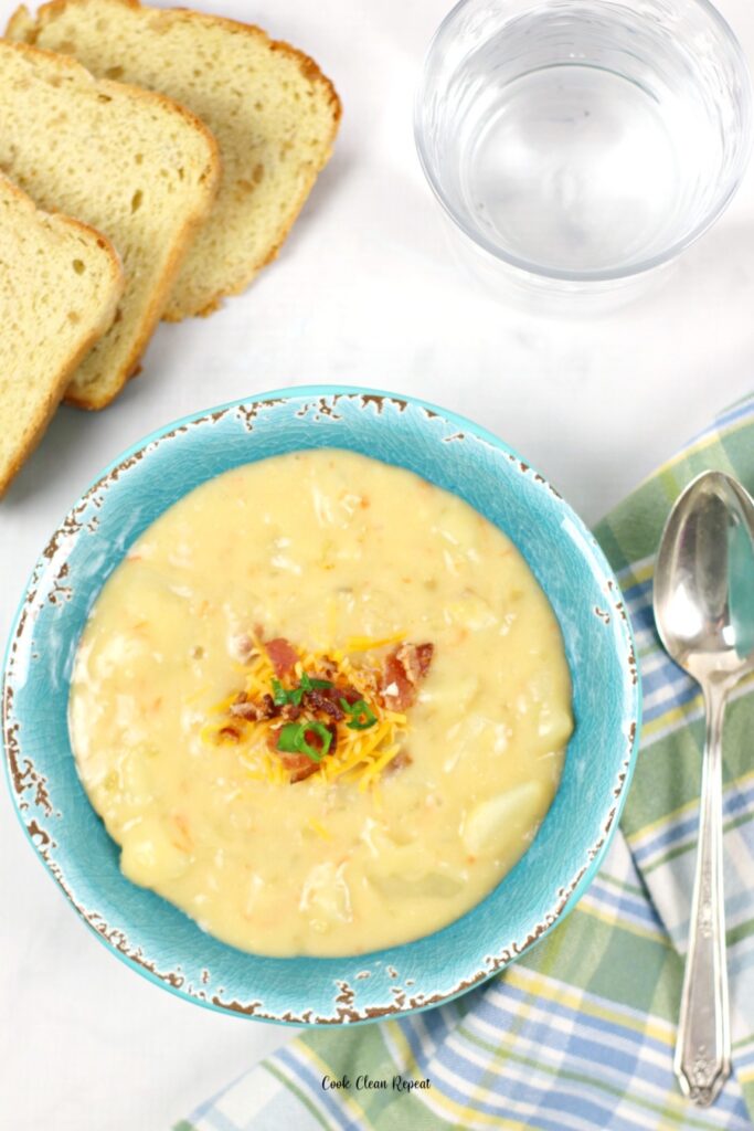 A top down view of tasty potato soup with cheese and bacon. 