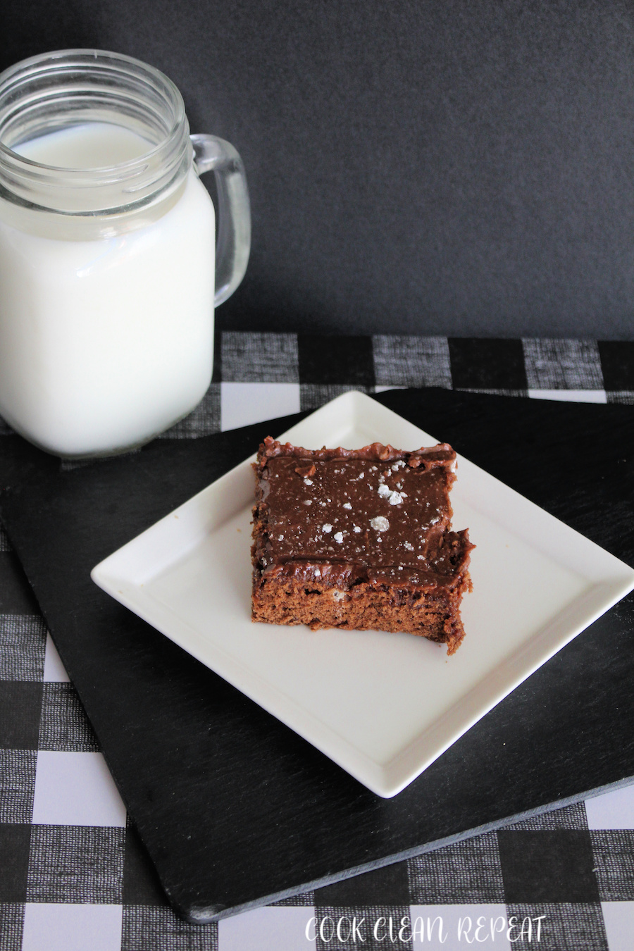 This featured image shows the delicious brownies from scratch ready to eat with a glass of milk on the side.