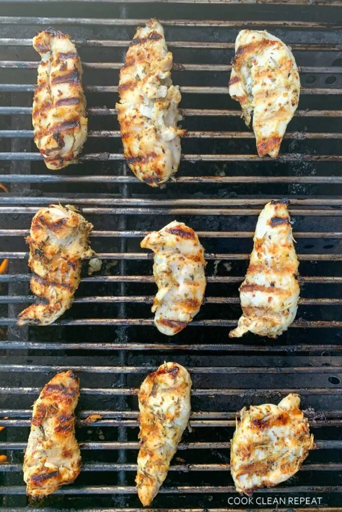 Chicken tenders on outdoor grill being cooked. 