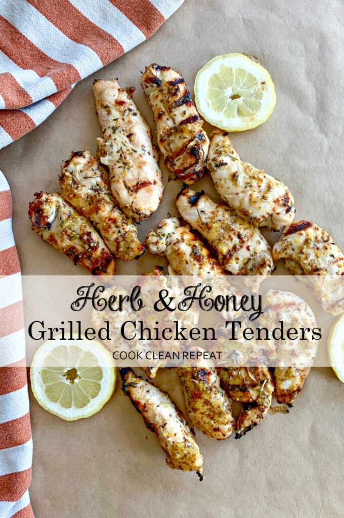 Cooked Herb and Honey Grilled Chicken on parchment paper with lemon slices. 
