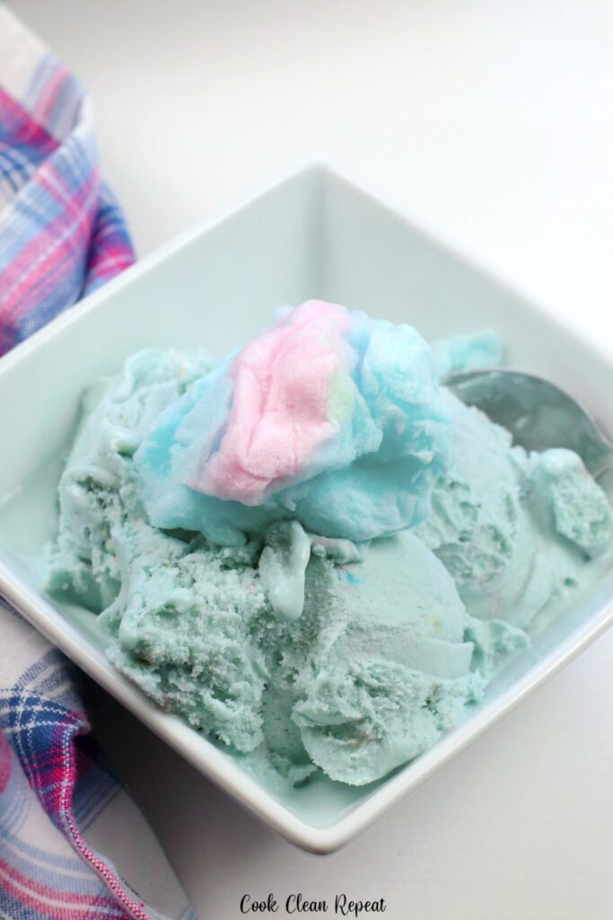 Cotton candy on top of a bowl full of ice cream
