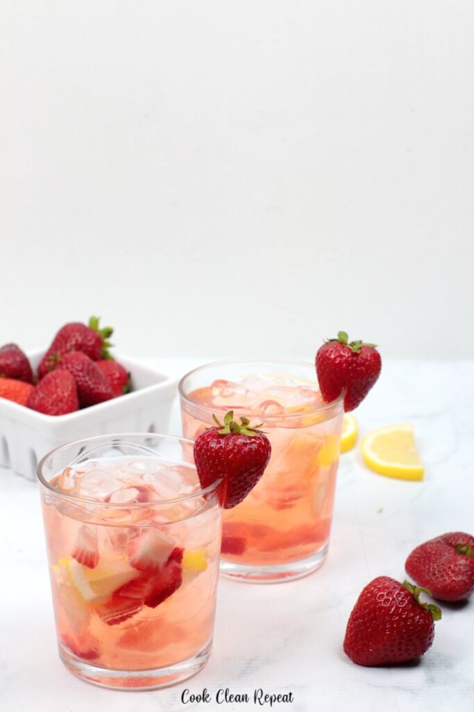 A close up of the finished strawberry lemon water garnished and ready to serve.