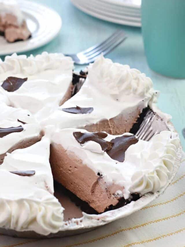 here we see the chocolate cheesecake pie with pudding cut and ready to be served on plates.