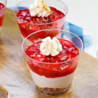 Featured image of the strawberry jello salad with cool whip on a wooden serving tray ready to be shared.