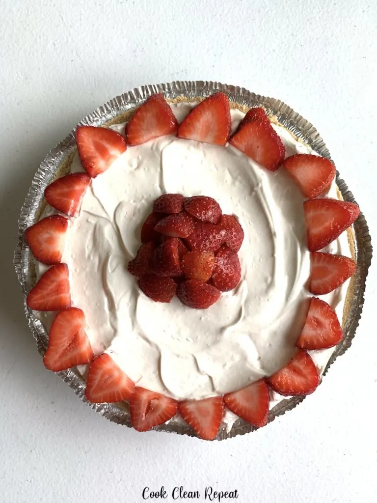A top down look at the finished and decorated no bake strawberry cheesecake. 
