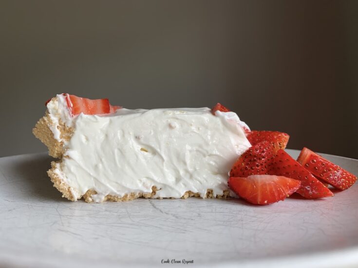 Featured image showing a single slice of the no bake strawberry cheesecake on a plate ready to serve.