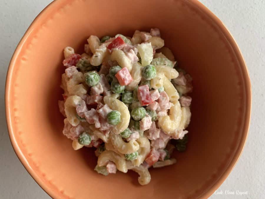 A bowl full of ham and pineapple pasta salad ready to be enjoyed.
