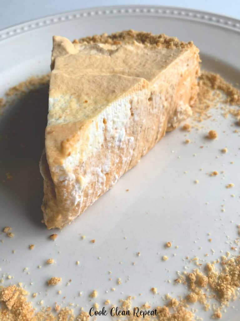 A slice of the finished pumpkin pie on a plate ready to eat.