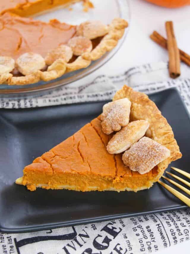 A top down look at a slice of pie with the finished pie in the background.