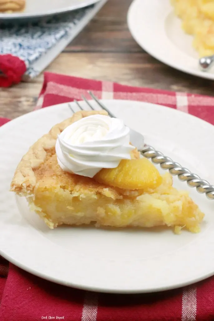 A look at a slice of the finished pineapple pie with whipped cream ready to eat. 