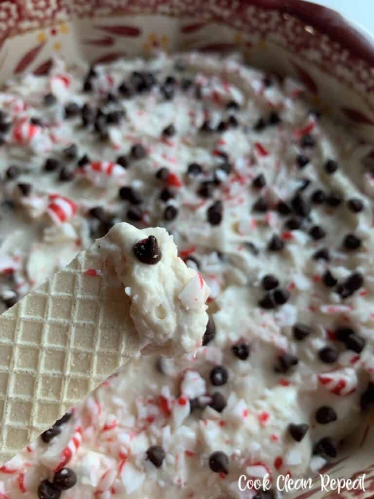 A scoop of dip on a cookie ready to eat.