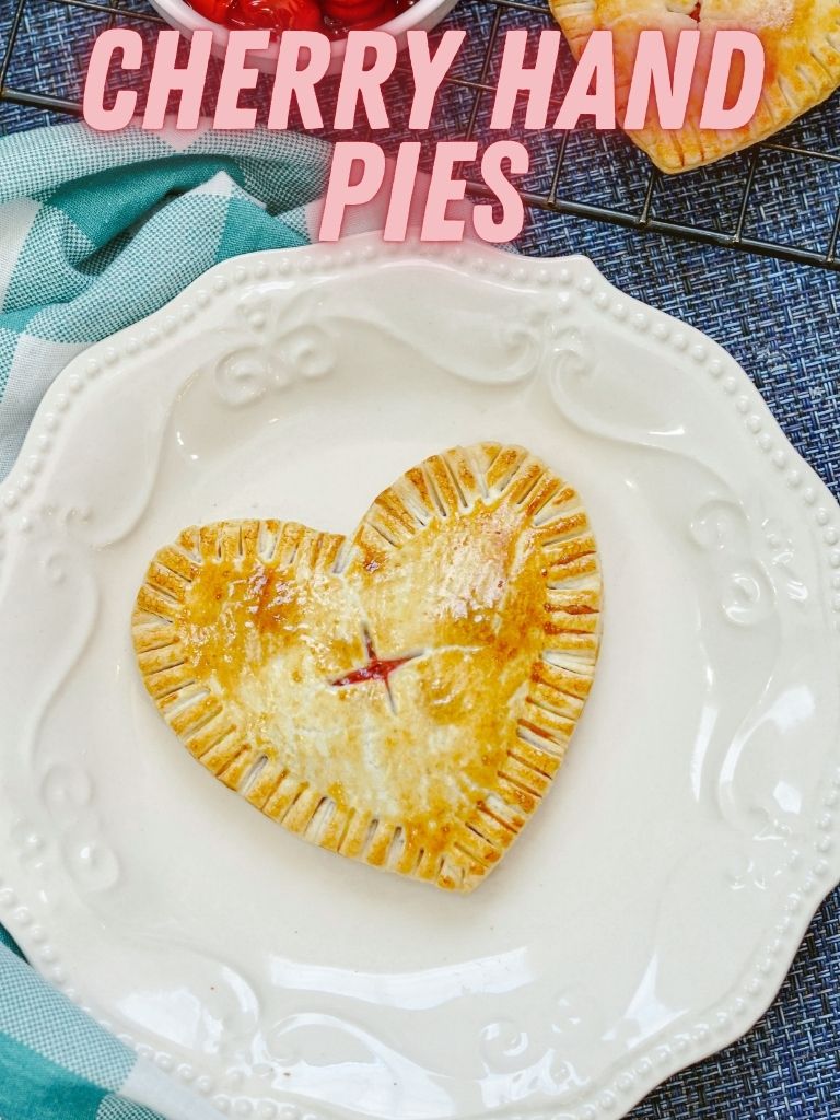 Pin showing the finished cherry hand pie with title across the top.