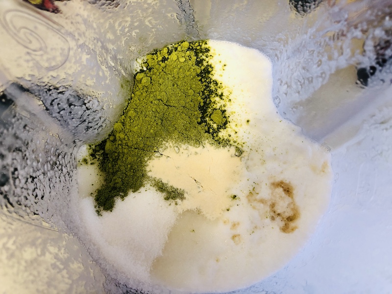 matcha and other ingredients being added to blender. 