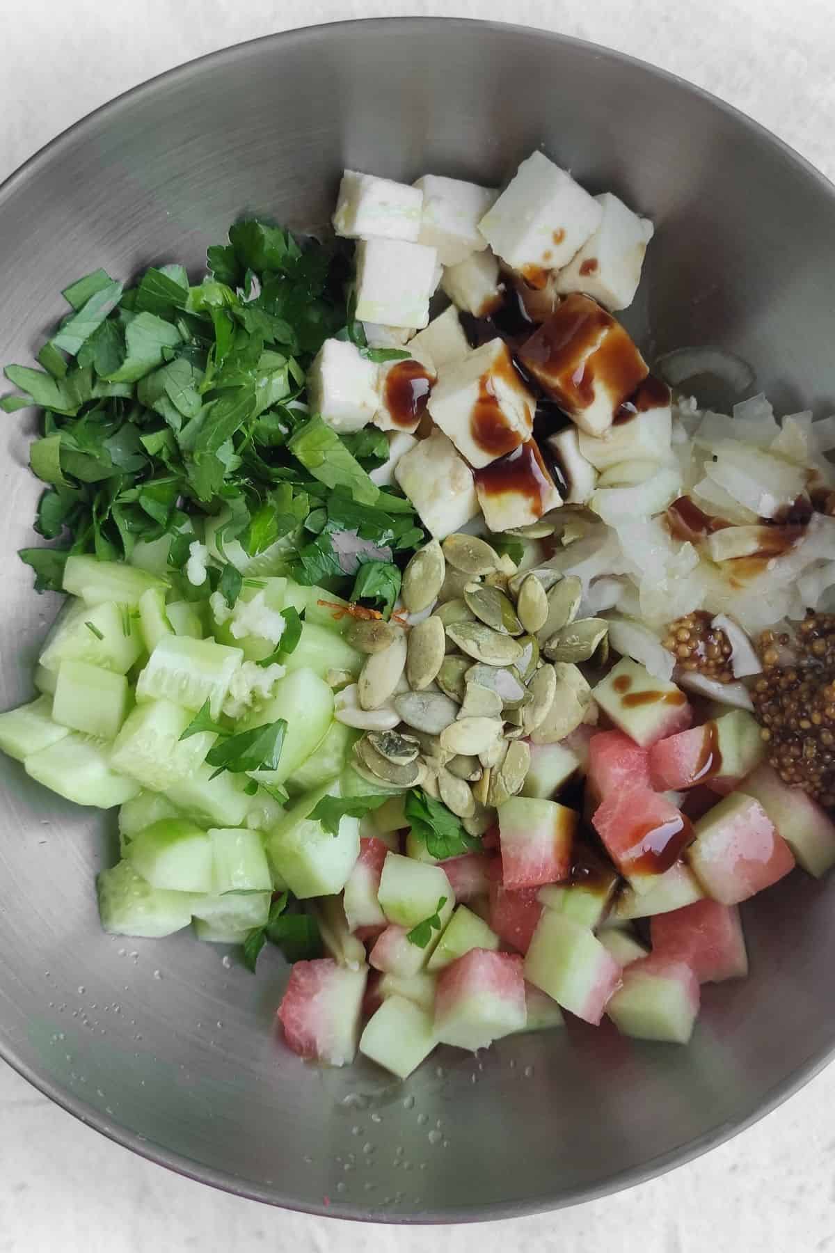 Mixing all of the ingredients together in a mixing bowl.