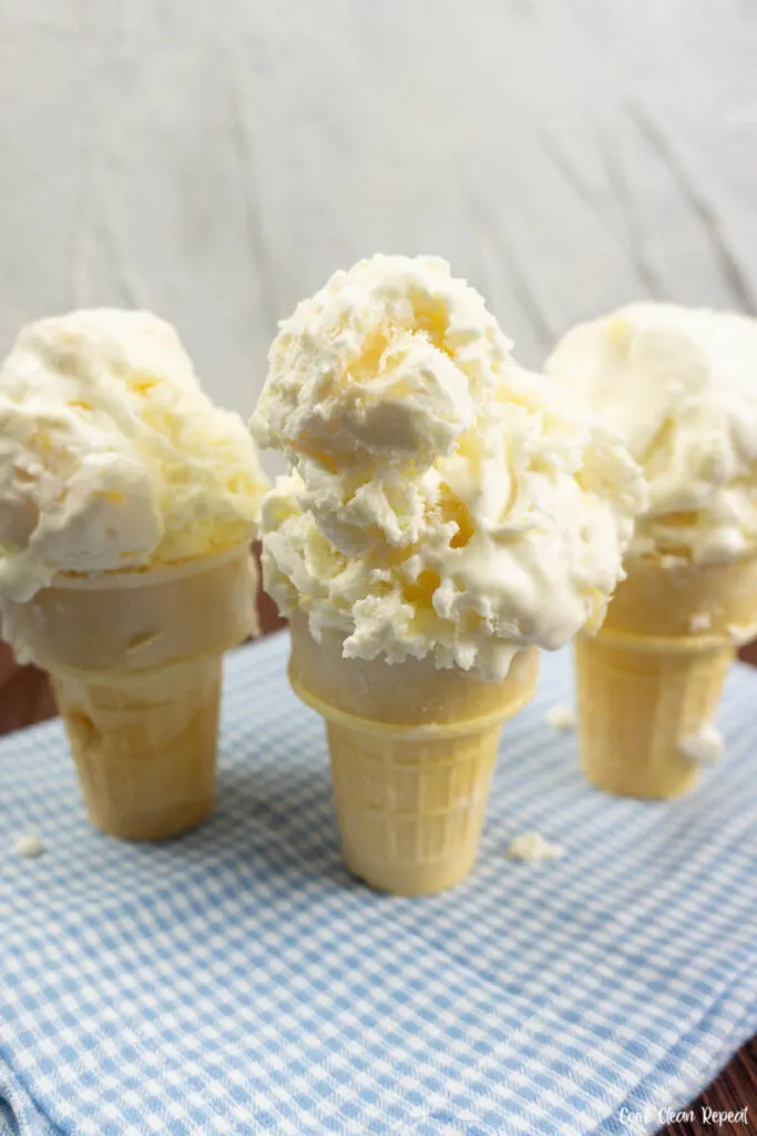 Cones of ice cream topped with two scoops ready to eat. 