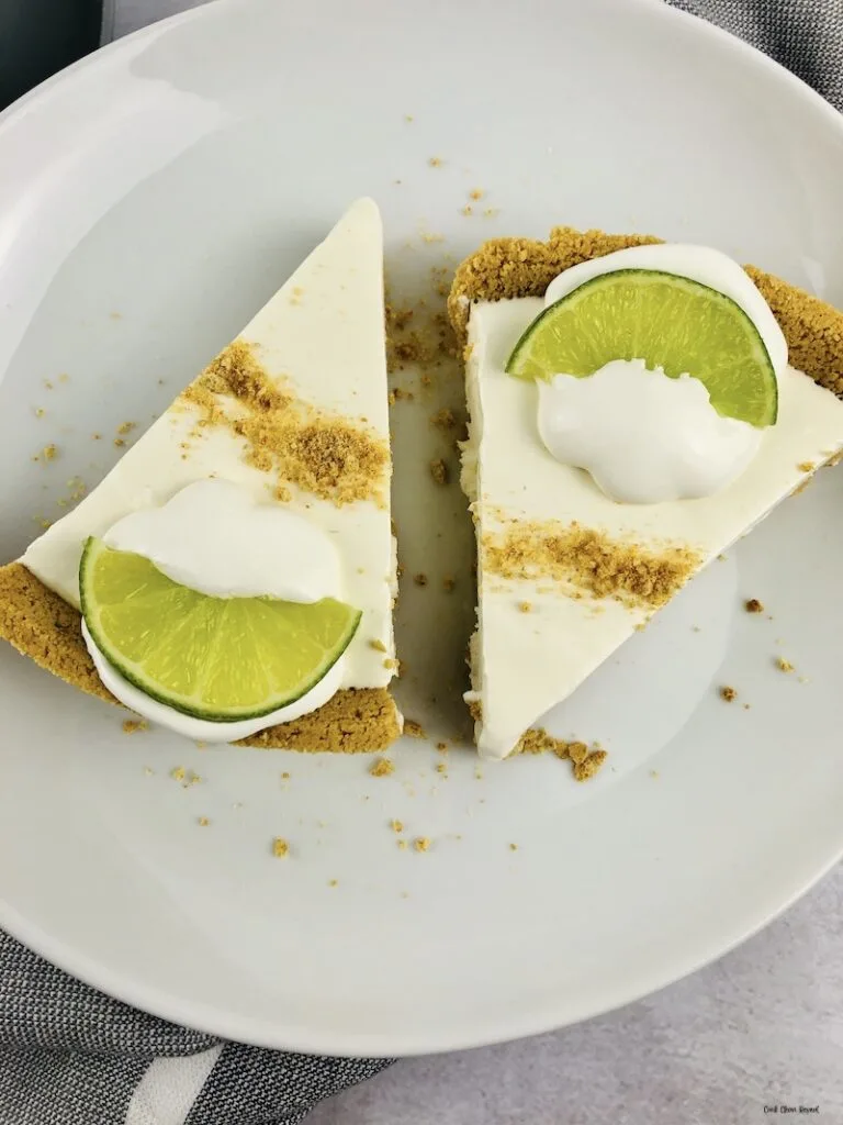 a close up of two slices of the finished key lime pie ready to eat. 