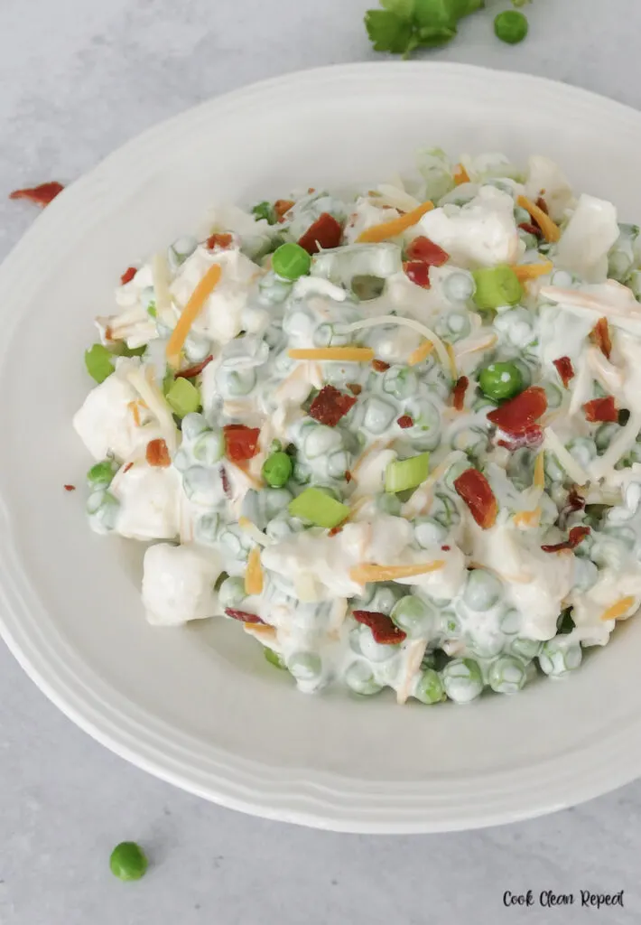 A bowl full of the delicious pea salad with ranch dressing. 