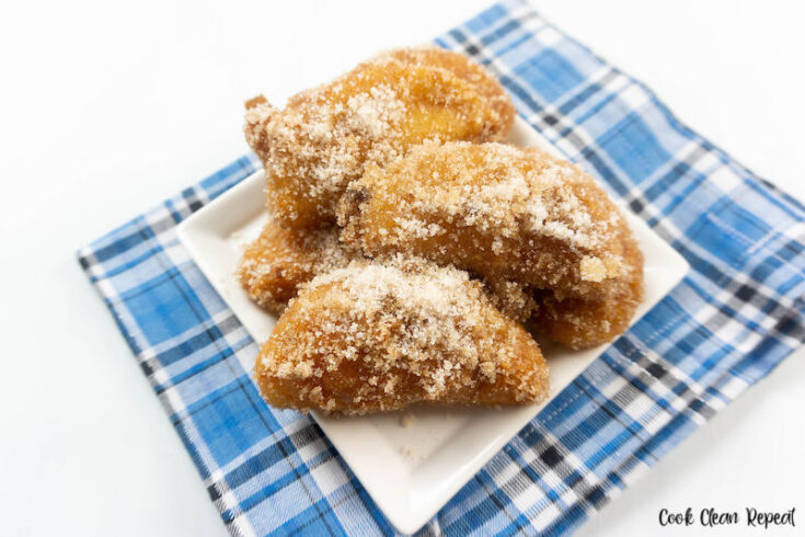 Featured image showing the finished fried apples recipe ready to eat on a plate, cinnamon sugar dusted on top of the fried apples.