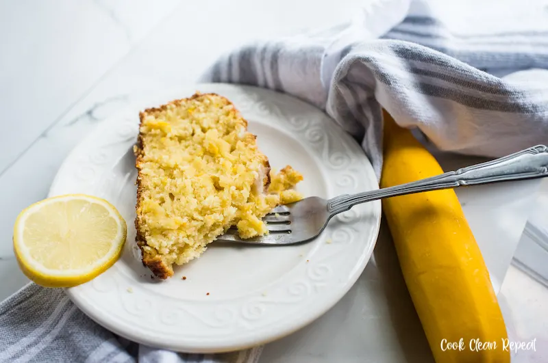A slice of the finished lemon summer squash bread ready to be enjoyed with a fork. 