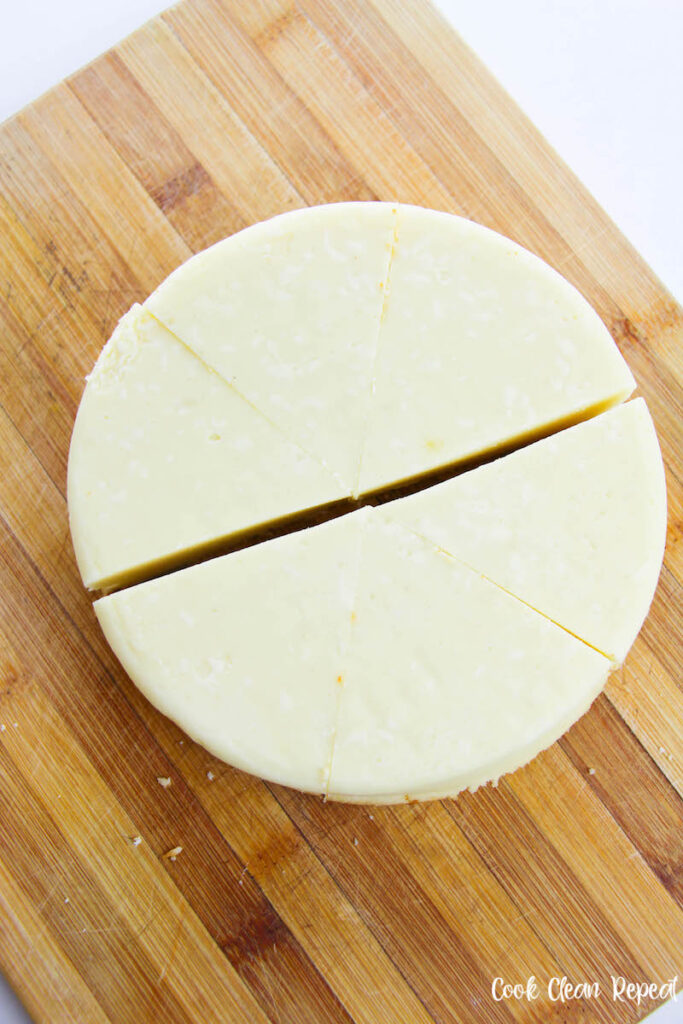 cheescake being cut into even slices. 