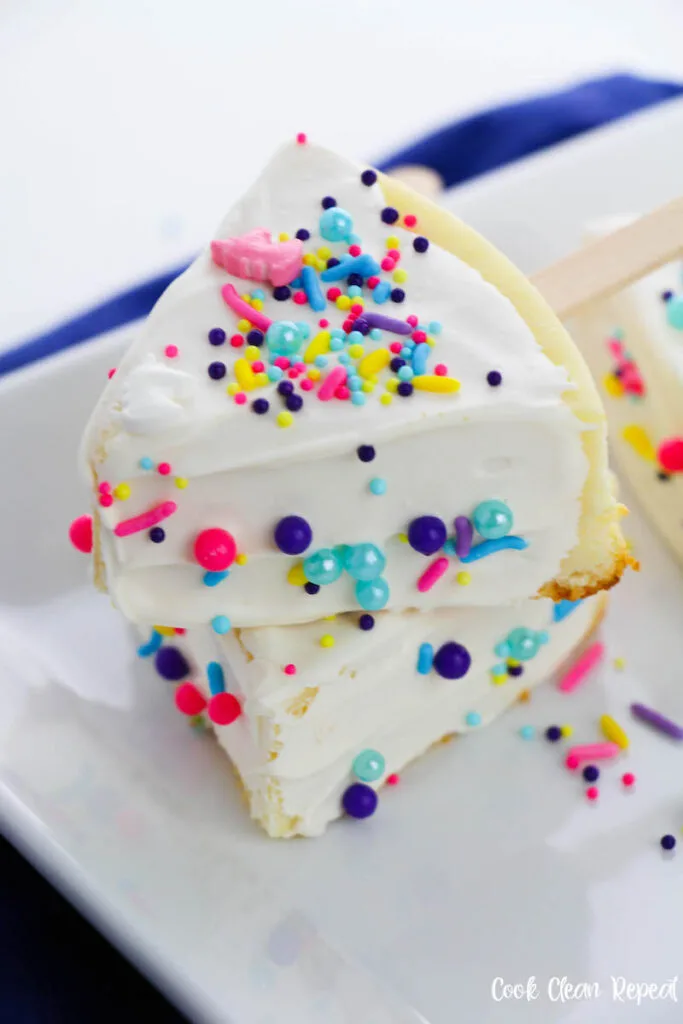 A close up of a stack of the unicorn cheesecake on a stick 