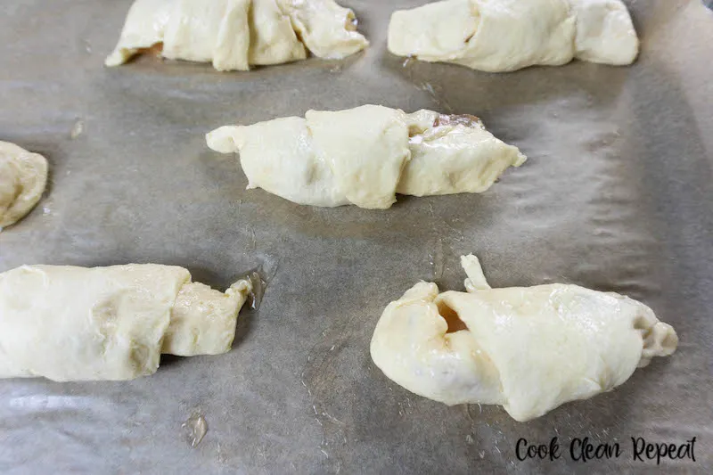 Crescent rolls filled and rolled up ready to be baked. 