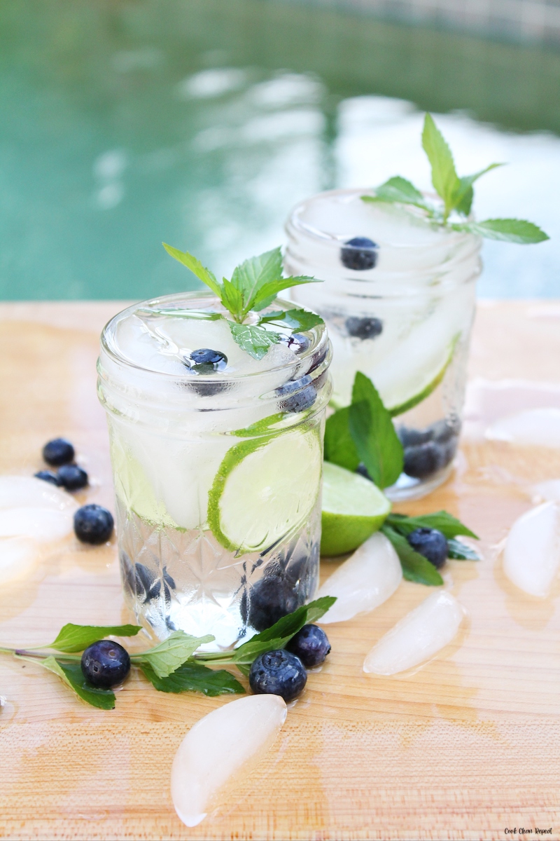 a few glasses of finished recipe for blueberry lime mint infused water.