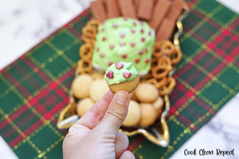 scoop of the grinch dessert dip on a cookie ready to eat.