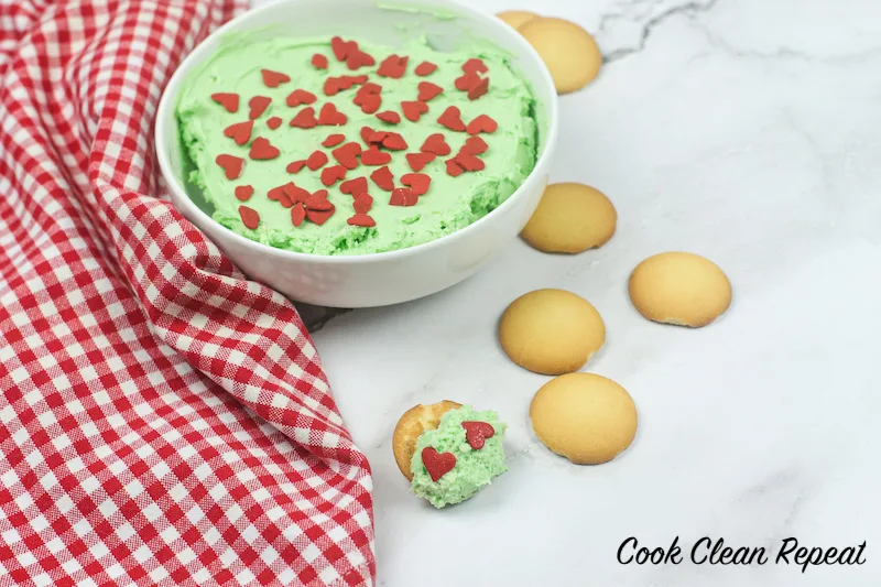 a scoop of grinch dip on a Nilla wafer cookie