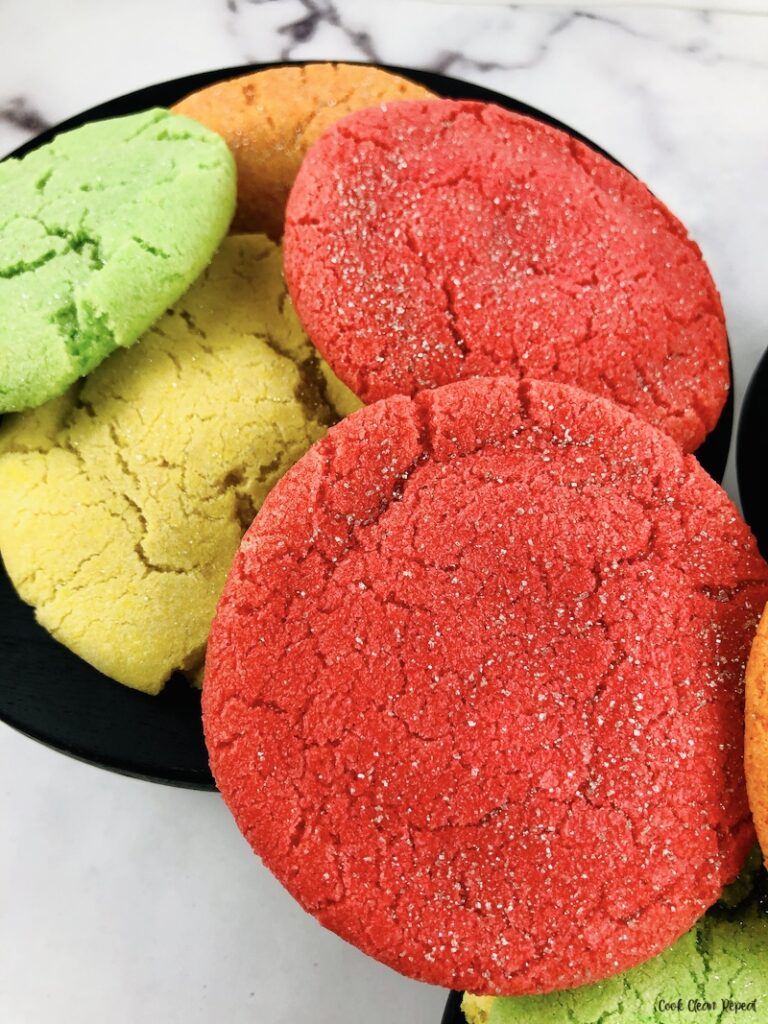A close up look at the red green yellow and orange cookies ready to serve. 