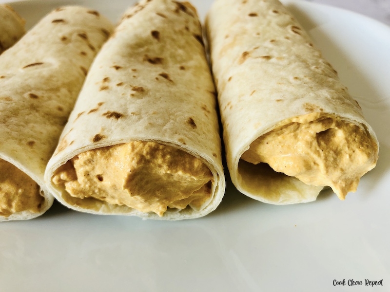 side view of the rolled up tortillas with filling. 