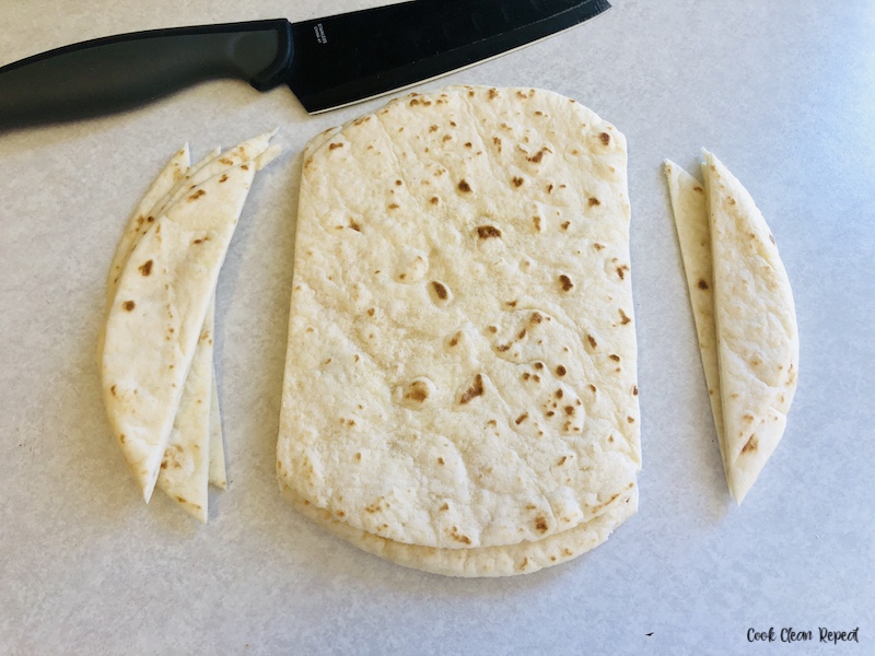 tortillas being trimmed to fit. 