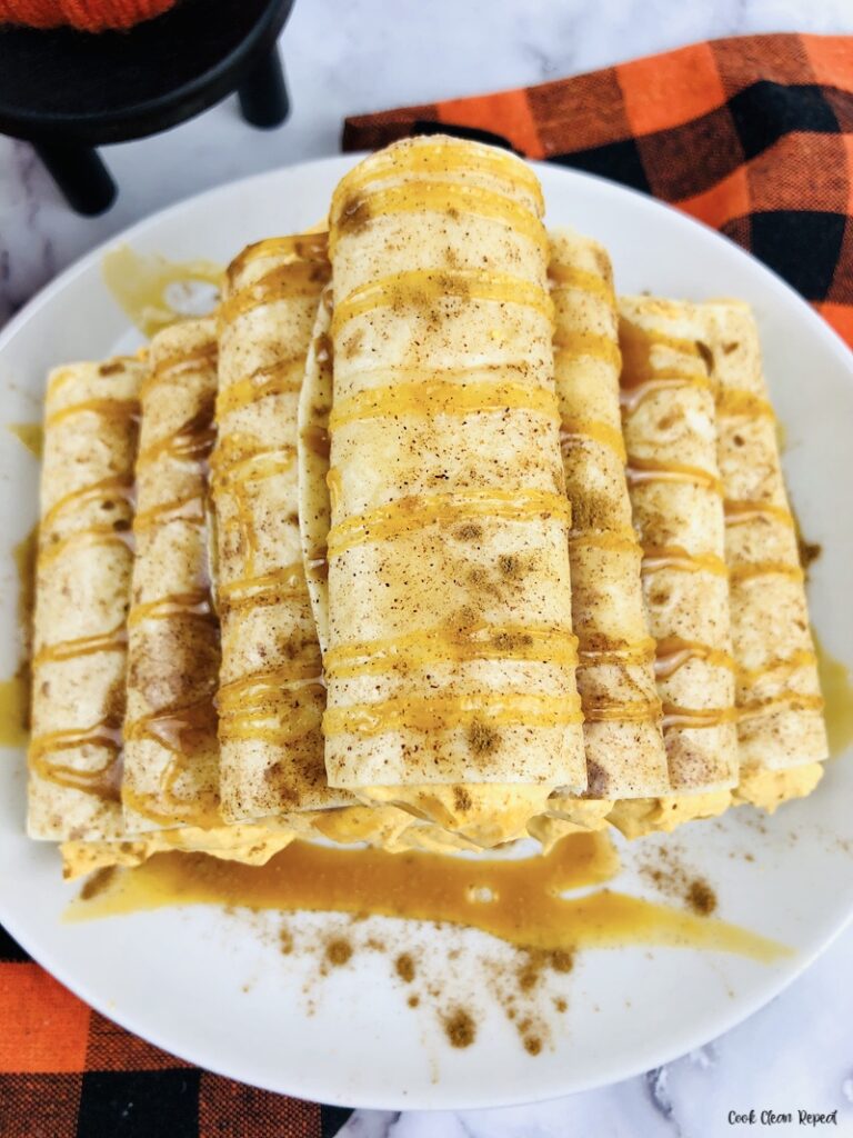 a stack of the finished no bake pumpkin cream cheese dessert roll ups. 