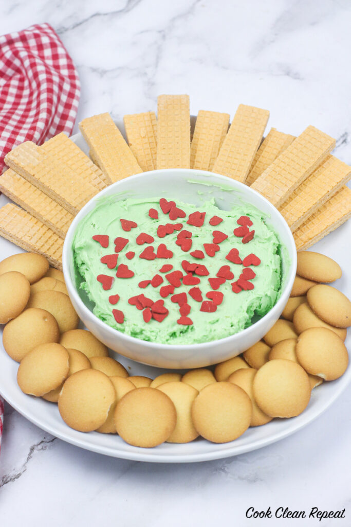 platter of cookies with grinch dip in the middle. 