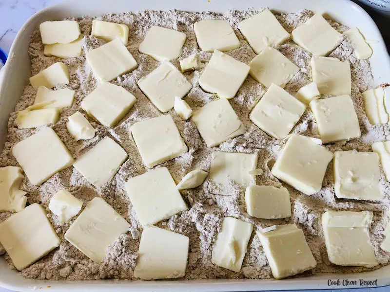 butter slices added to the top of the baking mix. 