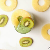 Featured image showing top down view of the finished mango pineapple kiwi smoothie