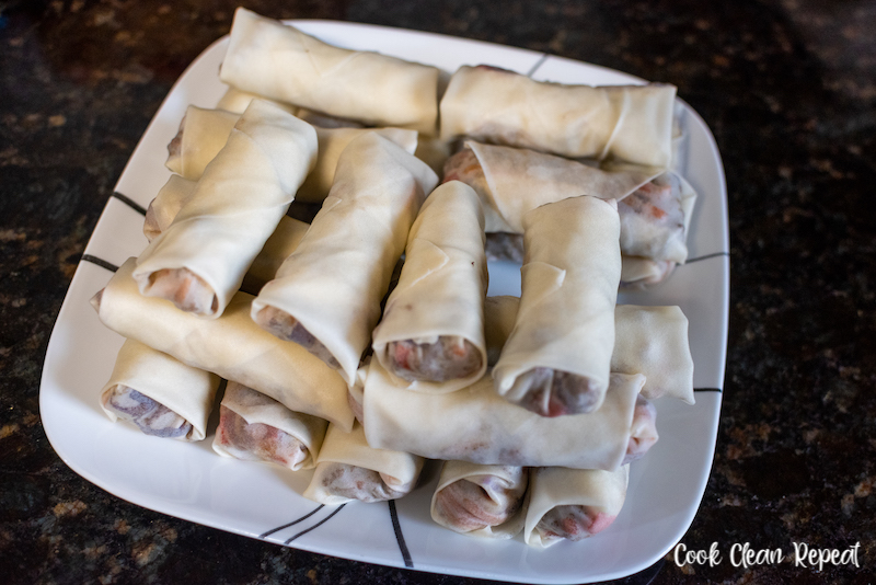 plate full of rolled egg rolls ready to fry